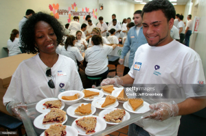 Volunteers serve meals at the annual thanksgiving lunch for the poor at Camillus House 
Jeffry Greenberg/Getty Images